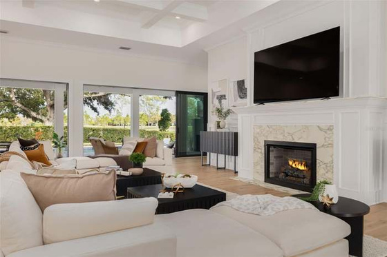 Bright, modern living room staged in a warm neutral palette